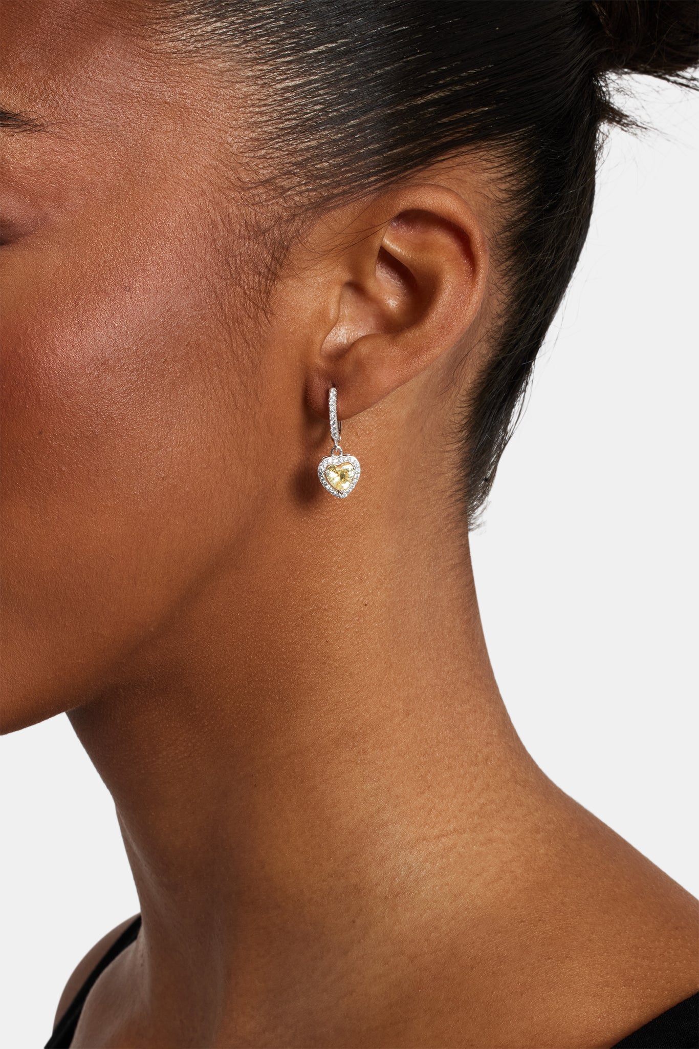 Female model wearing the lemon heart drop earrings